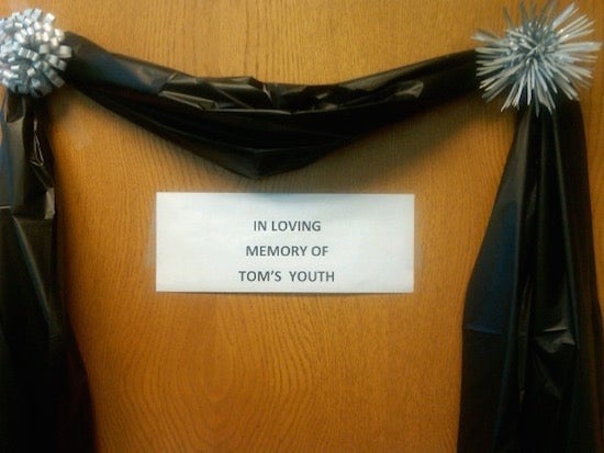 Sign that says "in loving memory of Tom's youth"