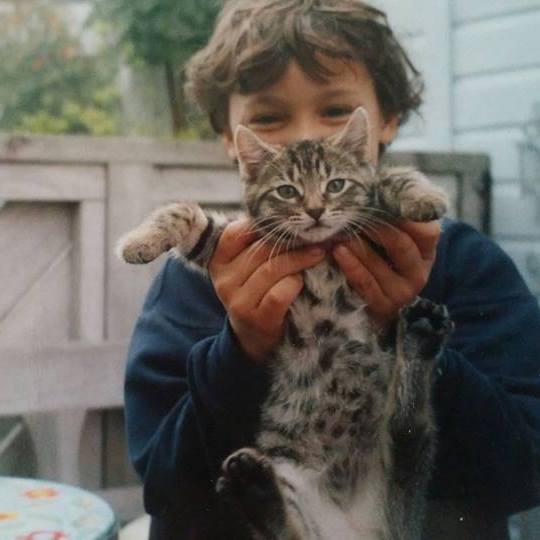 A little boy hold a cat 