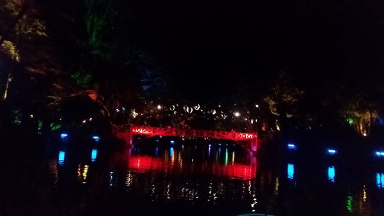 An illuminated red bridge in the dark