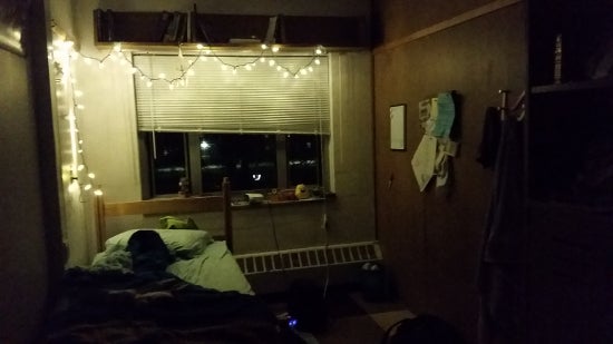 A string of lights along a wall and above a window.