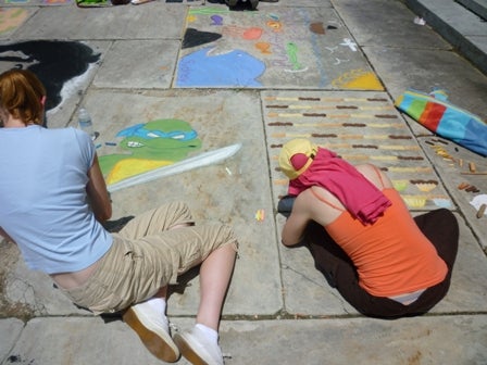 Artists making chalk drawings
