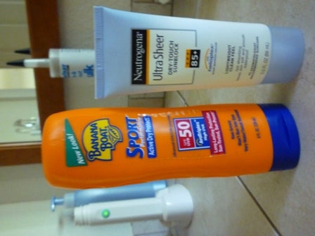 Two containers of sunscreen: Banana Boat Sport SPF 50 and Neutrogena Ultra Sheer SPF 85+.