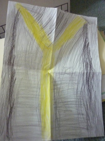 A poster-size crayon drawing of a yellow letter Y on a gray background.