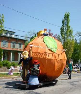 A huge peach with a kid on top