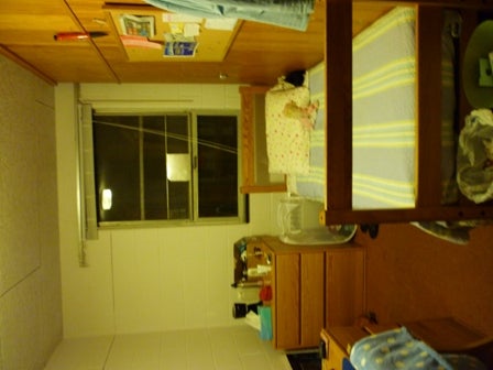 Dorm room bed, desk and window