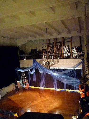 A stage with purple drapes 