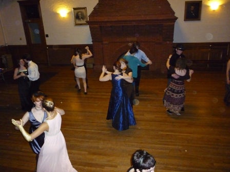 Couples dancing in ball gowns.