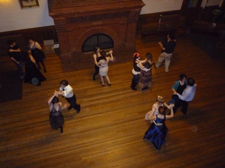 Couples dancing, as viewed from the balcony.