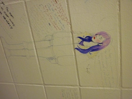A detailed drawing of a girl with purple hair drawn on a wall 