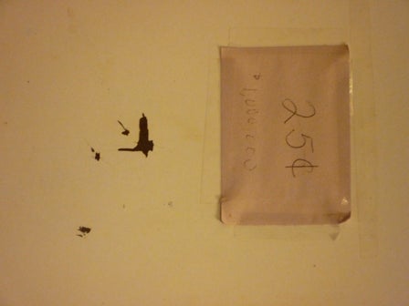 Paper taped to a wall with "25 cents" written on it