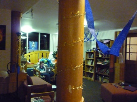 Crepe paper and garland decorate a lounge.
