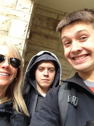 The author taking a selfie with his brother and mom