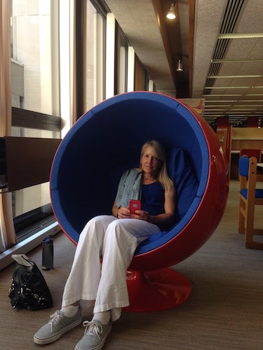 The authors mom sitting in a womb chair