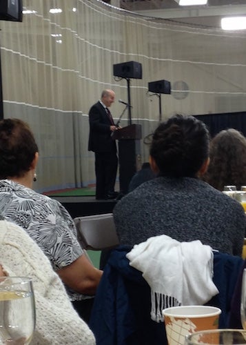 A view from the breakfast table of President Krislov speaking on stage