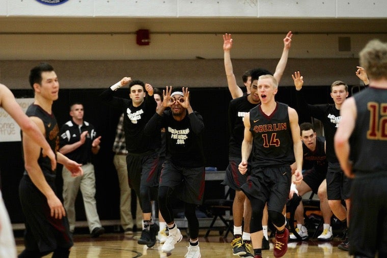 The boys basketball team cheering during a game