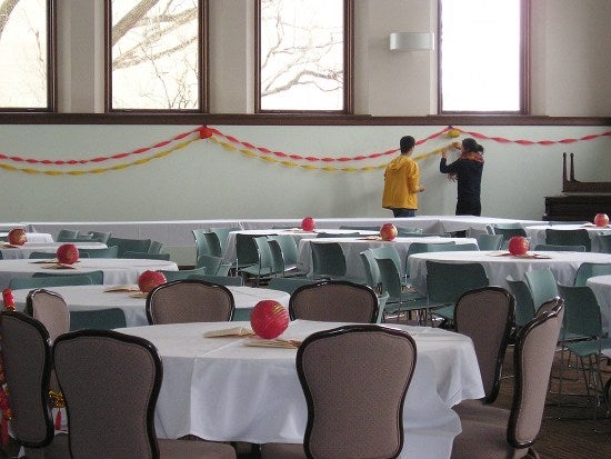 Students hanging red and yellow streamers 