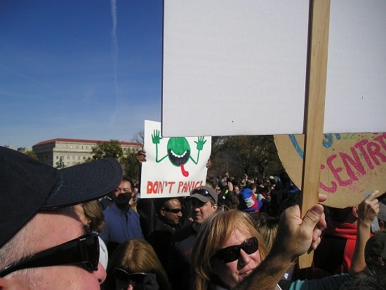 A protest with people holding signs 