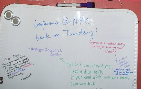 A whiteboard with many notes scrawled on it.