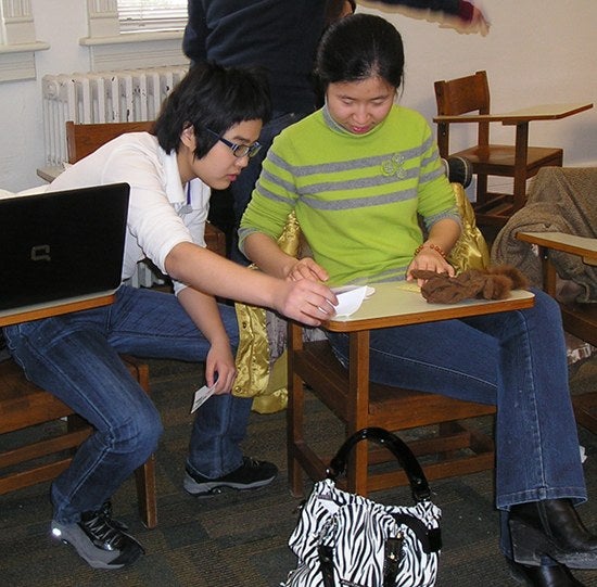 Students working at a desk together