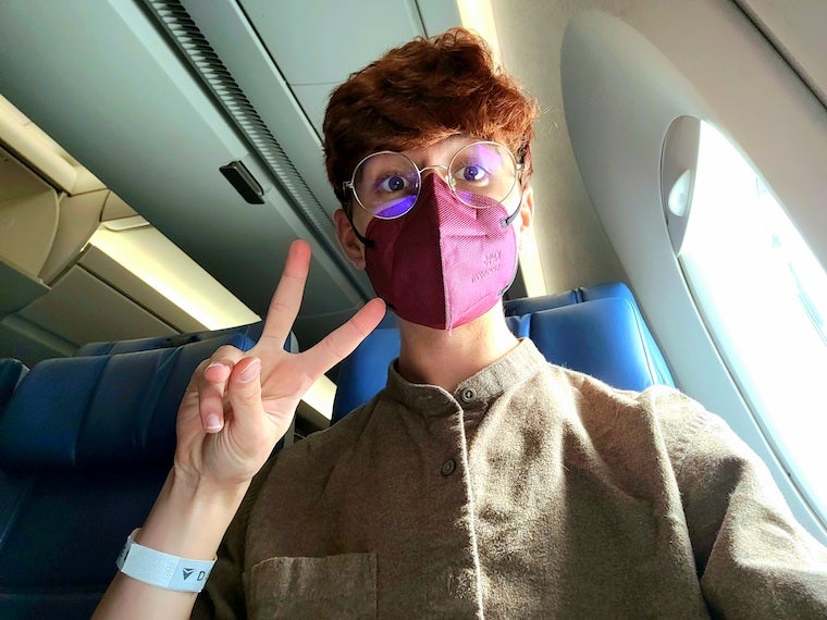 A selfie of me in my seat of the flight to Seoul.