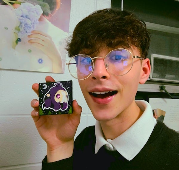 A selfie of me holding the Duskull painting. 