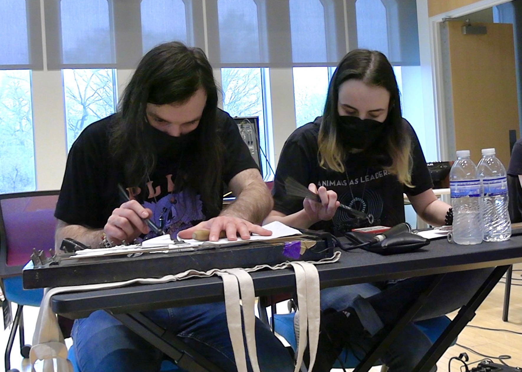 Two musicians improvosing on an auto-harp and found objects.