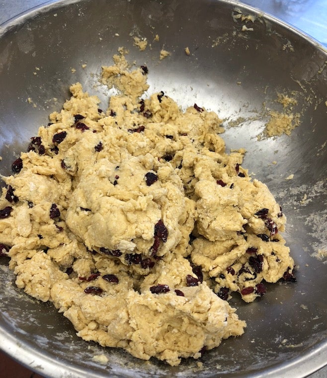 A mixing bowl filled with cranberry scone dough