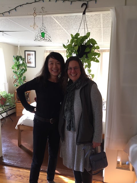 My mom and her Airbnb host in a room filled with plants