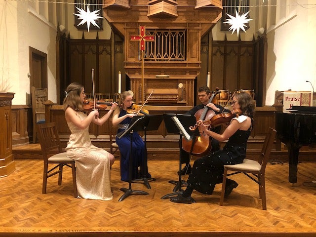 The Petrichor Quartet is performing a piece in a church