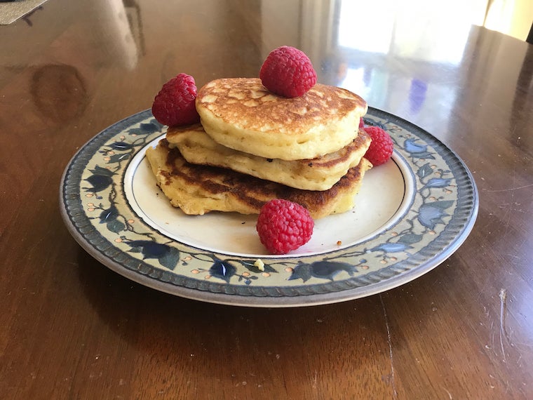 A photo I took of a plate of three hotcakes, with raspberries on top