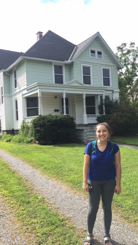 Kira in front of her house