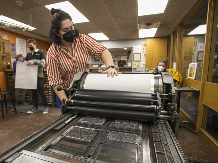 A student works on the letterpress.