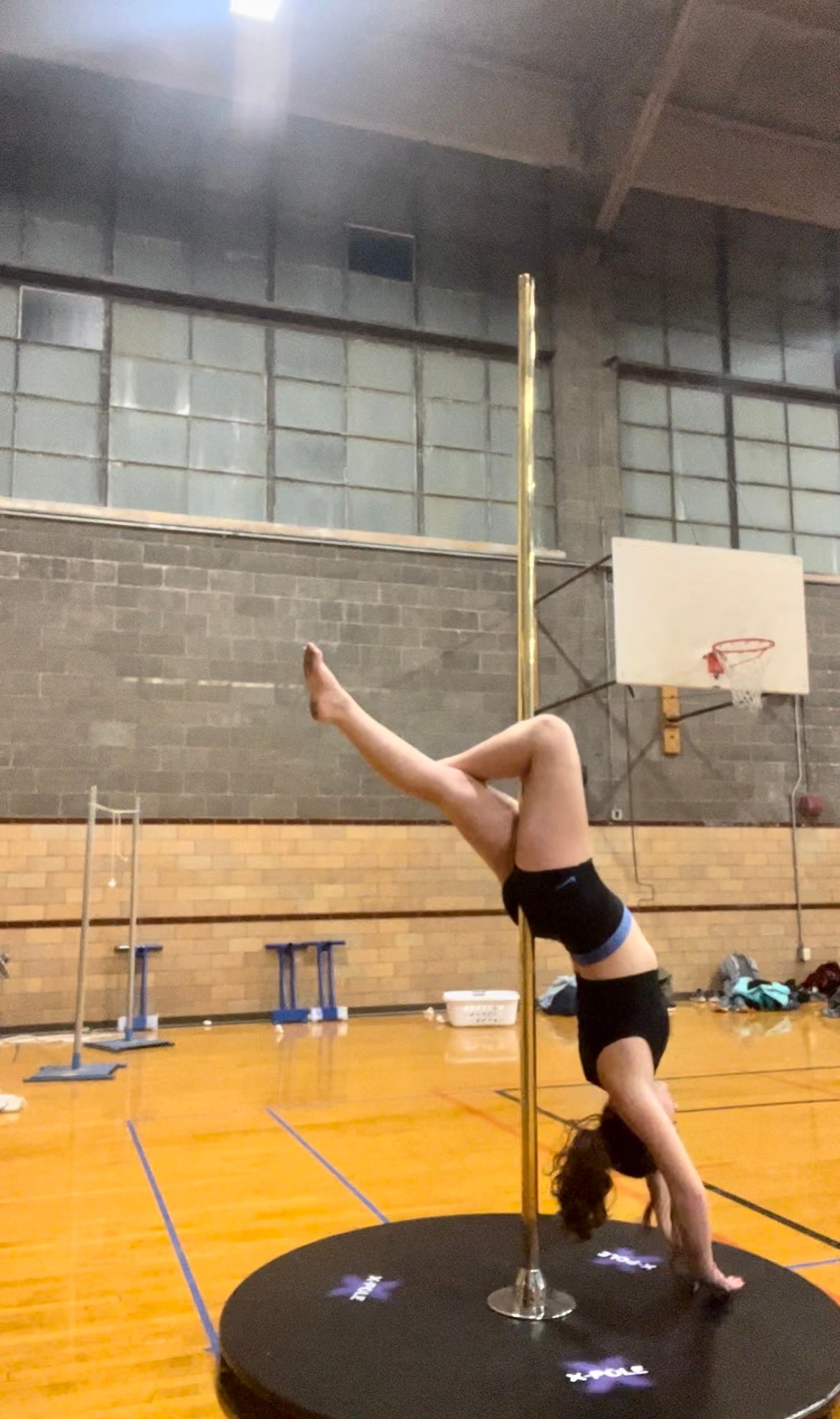 Natalie upside down on a pole