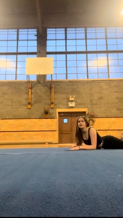Natalie laying on a blue mat