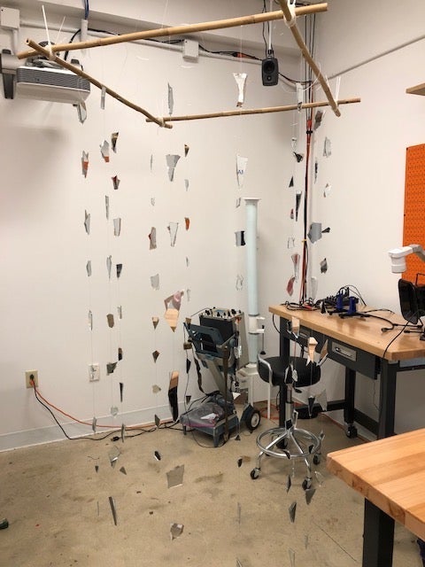 A mobile that has pieces of broken mirror hanging from it.