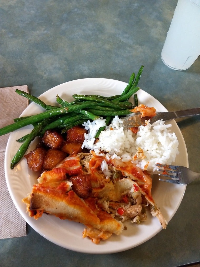 A plate of rice, green beans, tofu, and enchiladas