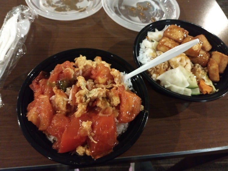 Two bowls, one of tomato-egg and one of teriyaki tofu.