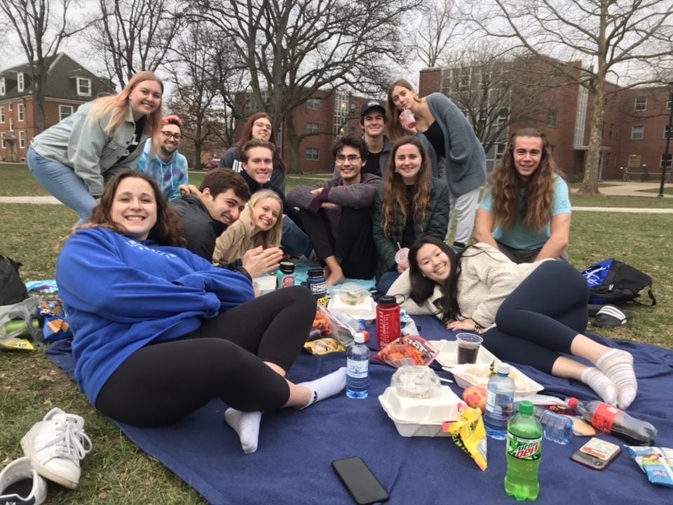 a group of students picnics on the grass in North Quad 