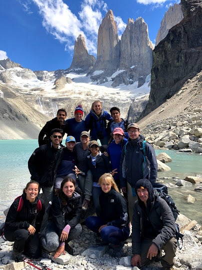 A group of people stands in front of Torres del Paine