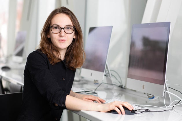 A person seated in front of a computer.