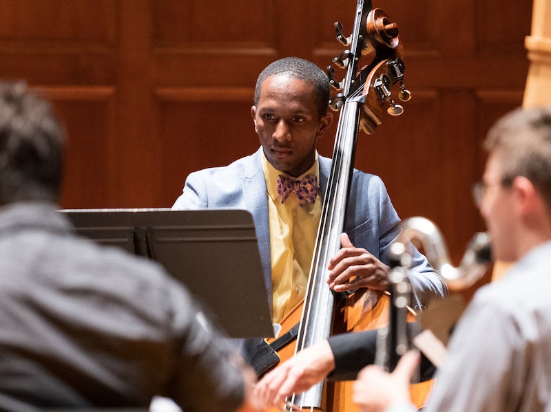 double bassist playing with an ensemble.