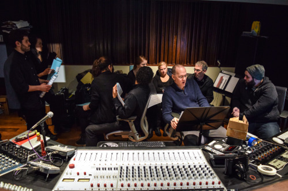 Musicians and recording professionals in the studio.