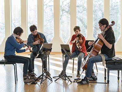 student quartet performing with iPads