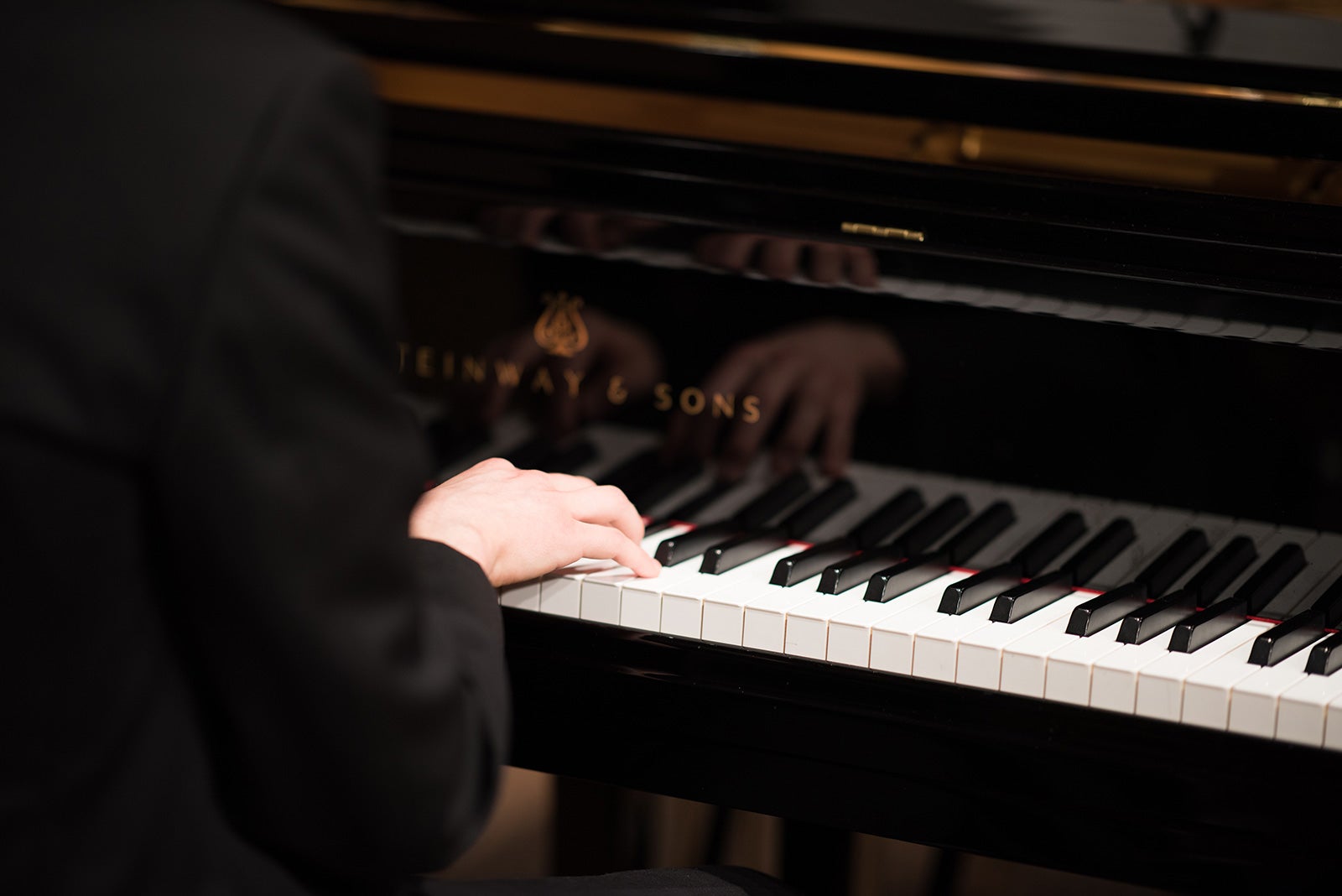 A pianist plays a Steinway & Sons piano.
