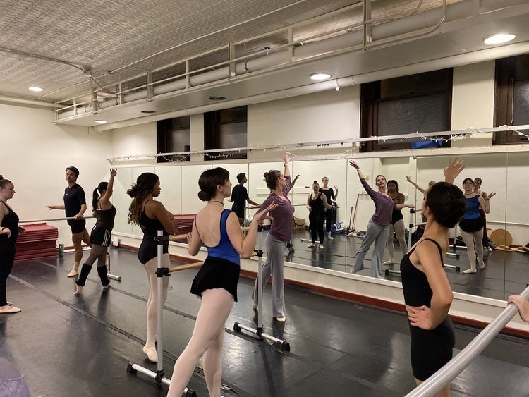 Janet Dziak demonstrates a combination at the barre to BalletO dancers.