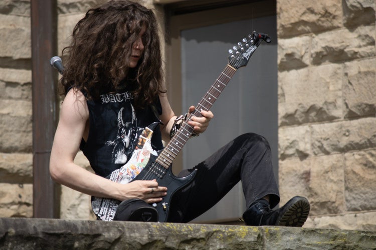 Student playing electric guitar