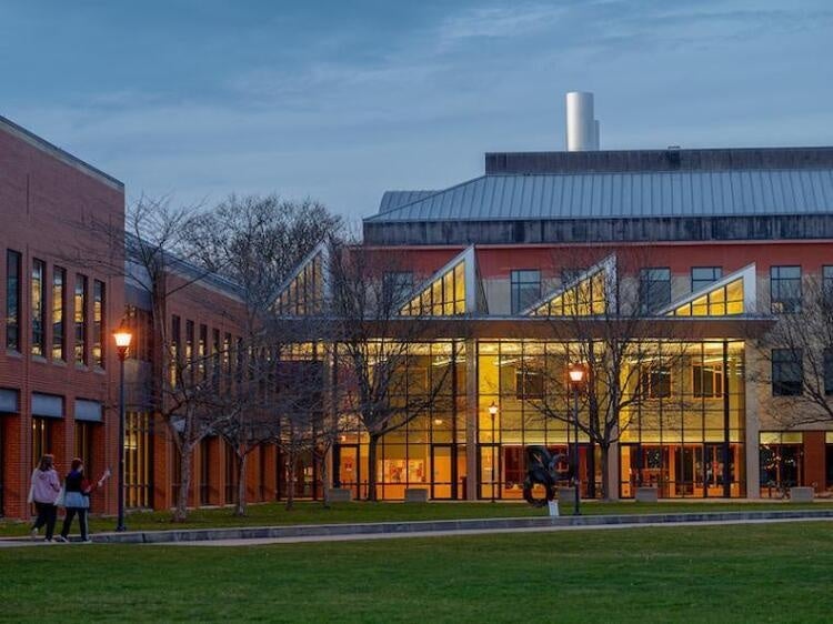 A picture of Oberlin's Science center during the spring with the lights on inside. 