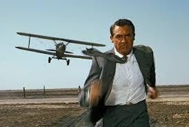 Man running with helicopter in background