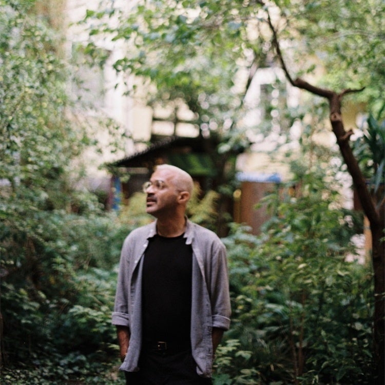 Omar Kasmani standing in a lush garden