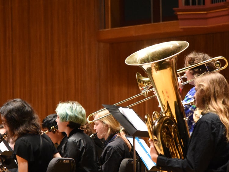 Students playing brass instruments in concert